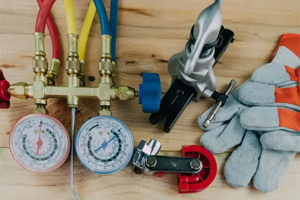 furnace parts and work gloves arranged on wood planks